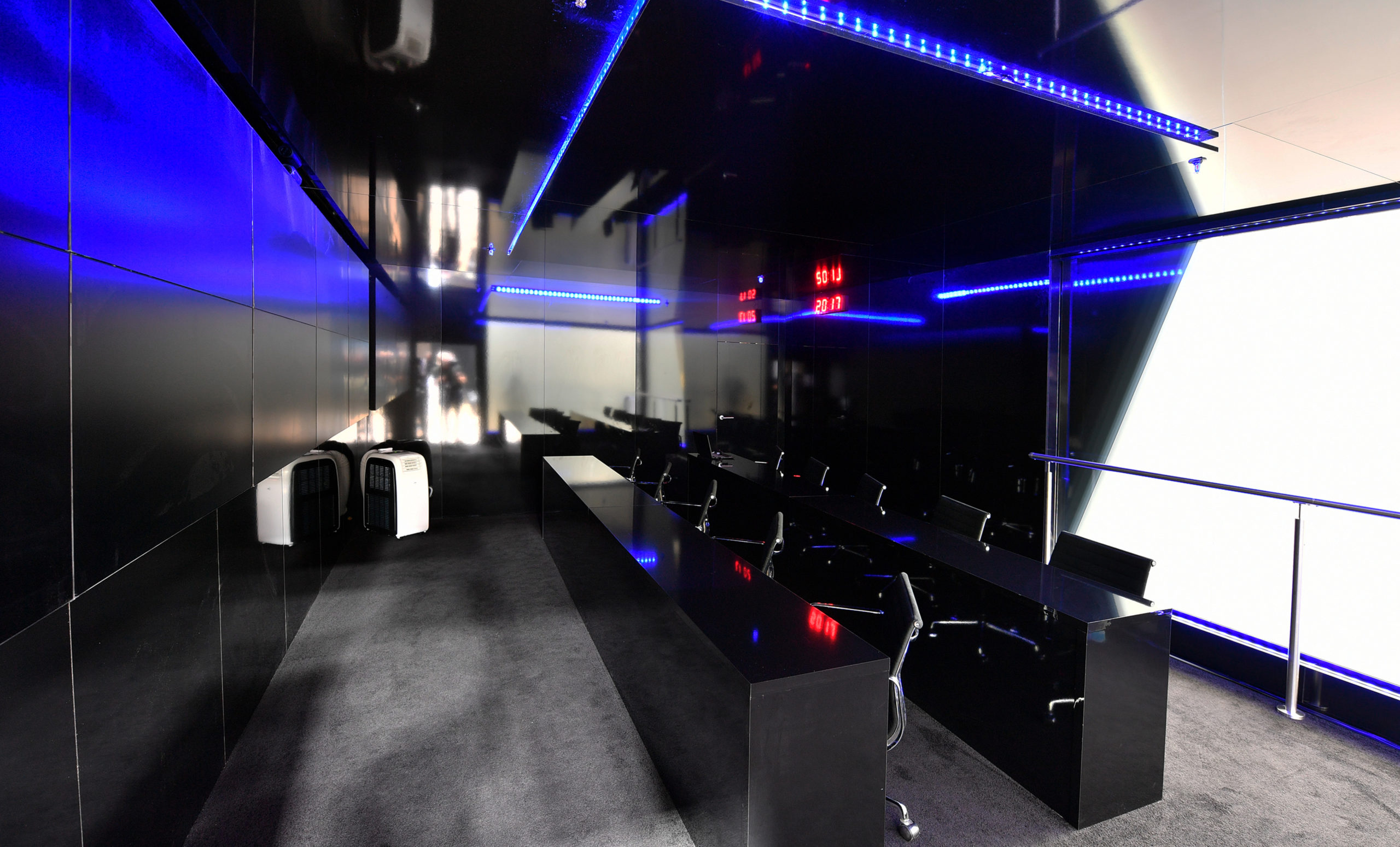 Dark control room setup with blue lighting in Converge custom trade show exhibit