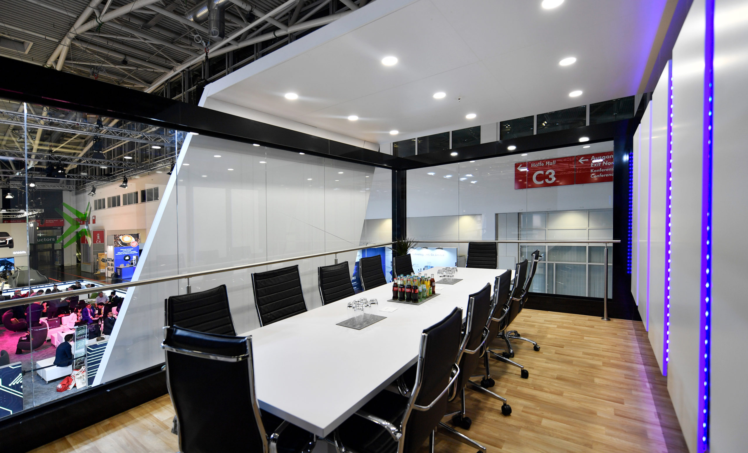 Executive boardroom setup in Converge trade show exhibit display with glass walls