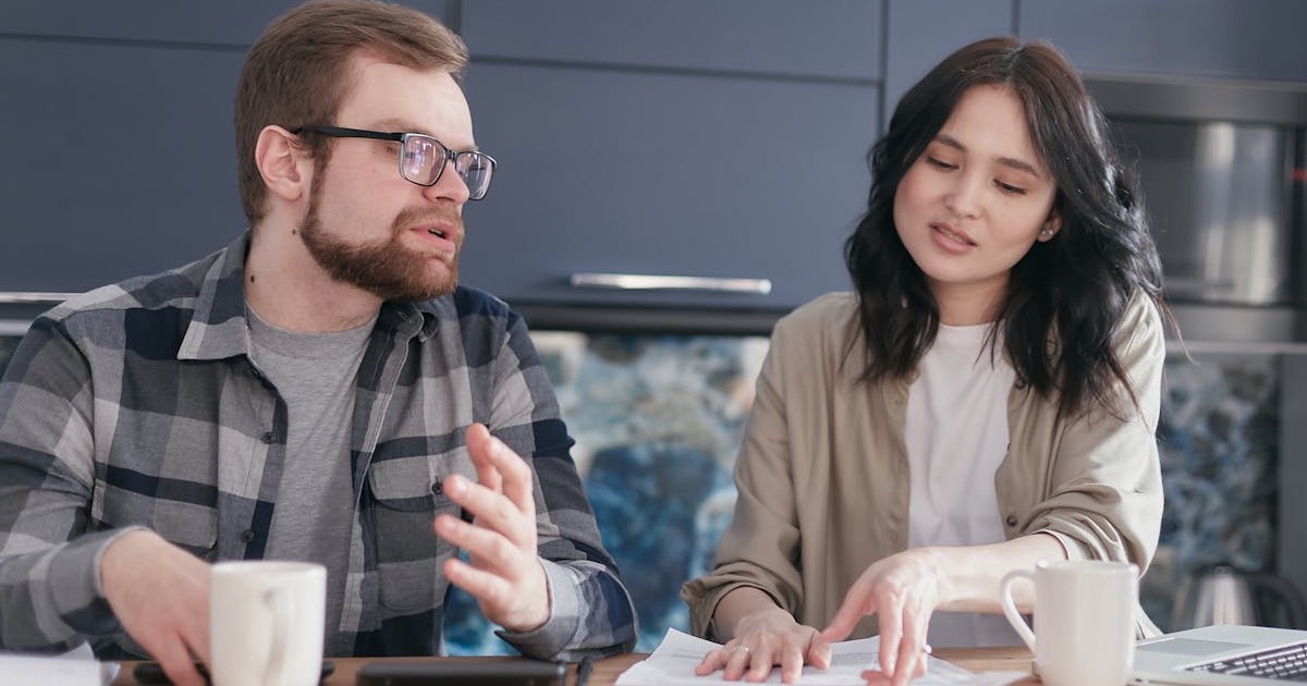 Two people working on a trade show budget