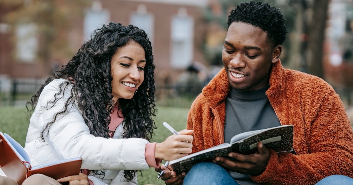 Two people sitting outside going over trade show plans